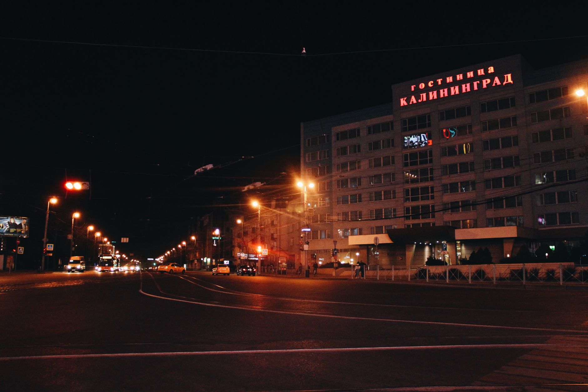 Dramatic nighttime view of street and hotel in Kaliningrad, Russia, showcasing its urban atmosphere.