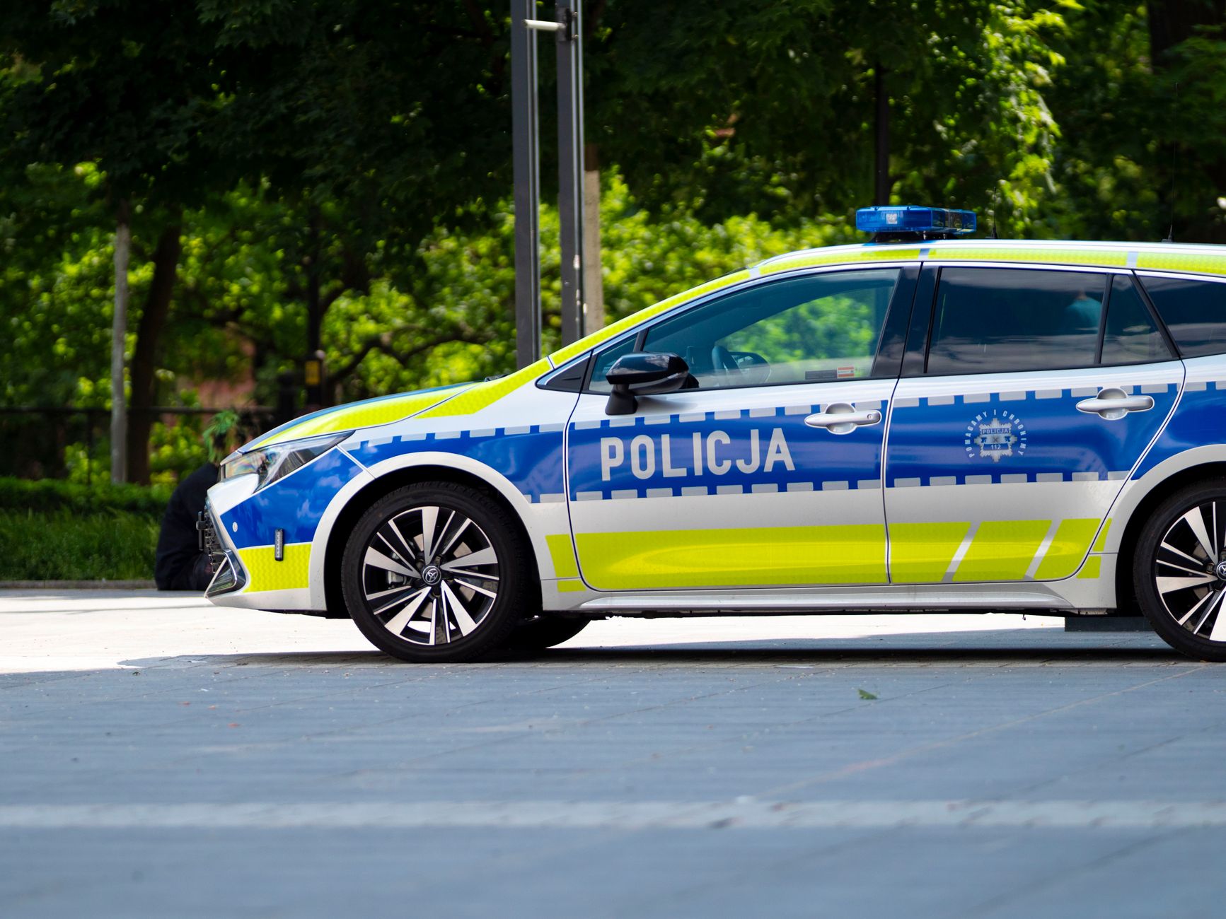 Polish police car parked outdoors in Wrocław, Poland, showcasing European law enforcement vehicle design.