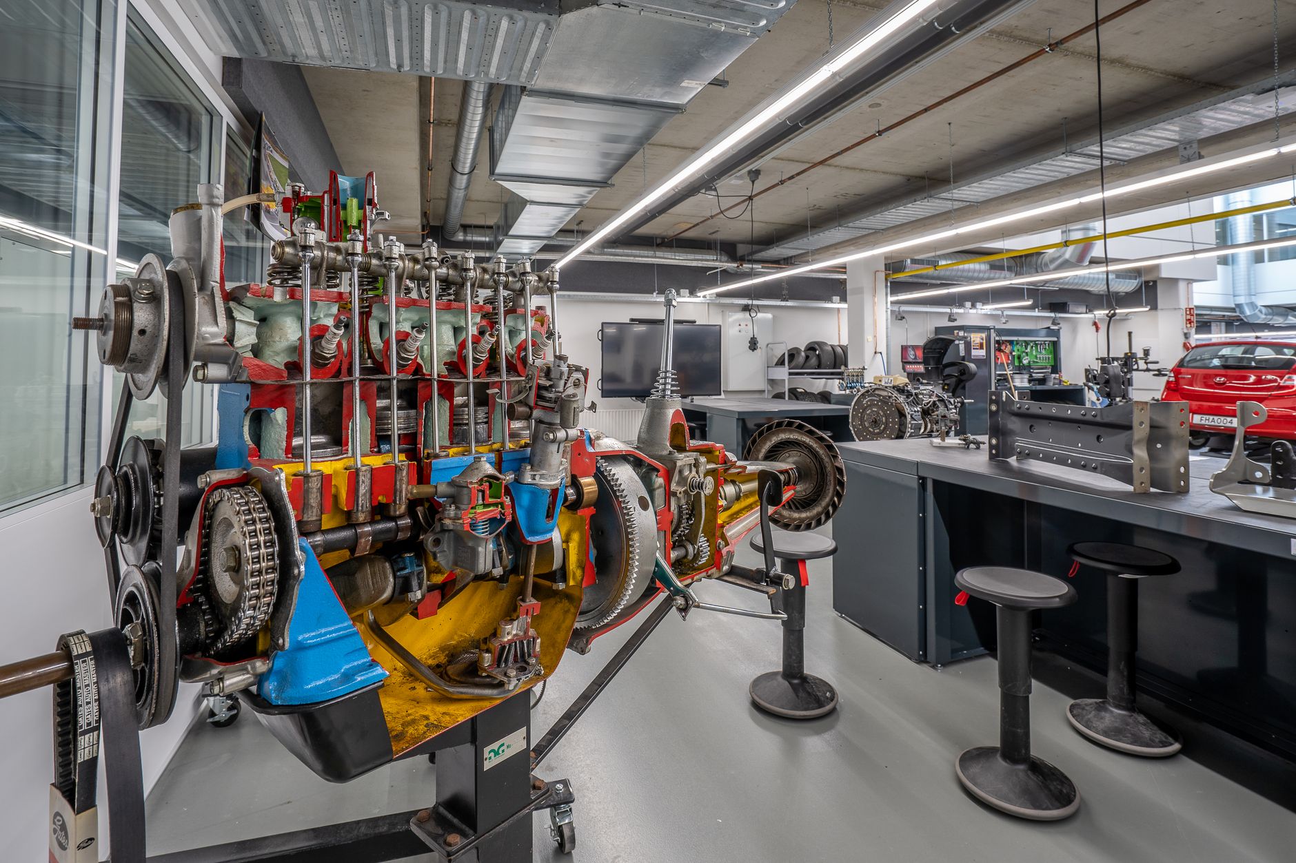 Interior of a modern workshop featuring detailed automotive machinery and equipment.