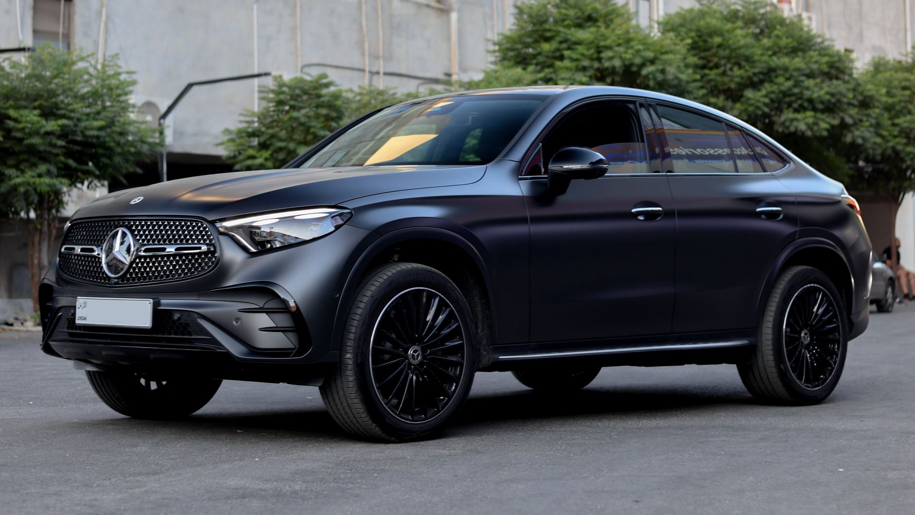 Sleek black Mercedes-Benz coupe SUV parked outdoors in Amman, Jordan.